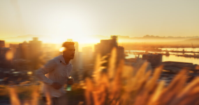 Man, running and sunset with exercise, training and city for fitness or cardio workout. Athlete, person and motion blur on mountain for wellness, health and summer marathon performance or endurance