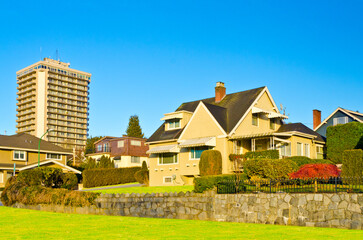 Neighbourhood of luxury houses in summer with street road, big trees and nice landscape in Vancouver, Canada. Blue sky. Day time on August 2024.