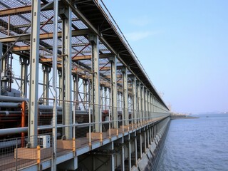 Metal structure of dam pipes and platform at water reservoir with copy space for text, pipes, industrial zone