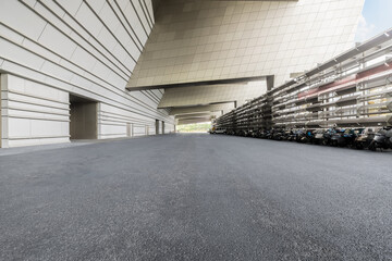 Empty asphalt road passage and city buildings