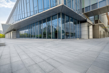 Fototapeta premium Empty brick floor and modern city buildings background