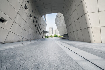 Empty brick floor passage and buildings in modern city