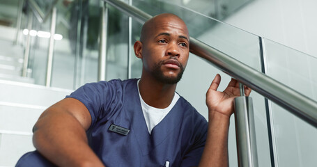 Nurse, sad and black man with stress, depression or regret patient loss on steps in hospital....