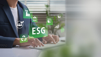 ESG Insights in Action, Business Leader Typing Sustainability Metrics, Emphasizing Ethical Corporate Practices, Carbon Reduction, and Green Innovations in Renewable Energy Goals for Future Growth