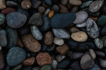 Wet pebbles on the sea shore