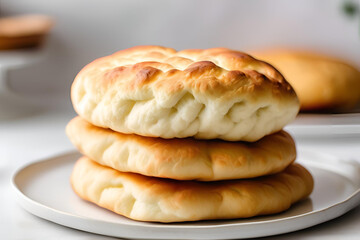 Fluffy, golden cloud bread on a clean white plate. The bread has a light, airy texture with a slight golden crust.
