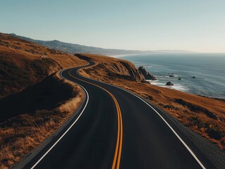 Fototapeta premium Winding coastal road with asphalt surface, overlooking the ocean, coastal highway, scenic drive