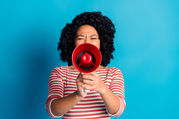 Obraz premium Photo of crazy charming girl wear stylish striped clothes hold bullhorn announce news isolated on blue color background