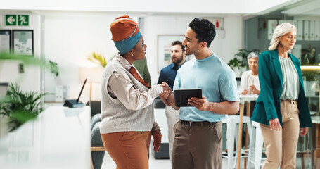 Tablet, happy team and business people shaking hands for collaboration, thank you or support in creative startup. Technology, partnership and handshake for project funding, sponsorship or agreement