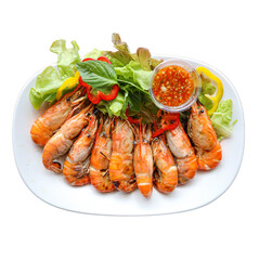 A platter of fresh, cooked shrimp served with a tangy dipping sauce and garnished with lettuce and colorful peppers.