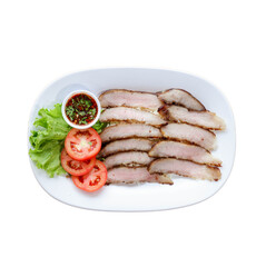 Sliced meat arranged neatly with fresh tomatoes, lettuce, and a small bowl of sauce on a white plate.