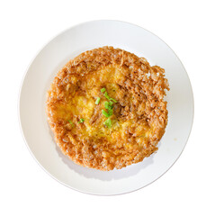 A golden, crispy fried dish garnished with green herbs, served on a round white plate.