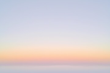 Soft Sunrise Sky Over Ocean Horizon with Gentle Pastel Colors Transitioning from Light Blue to Warm Peach, Creating a Peaceful and Serene Atmosphere