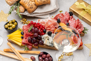Party charcuterie board italian food antipasti prosciutto ham, salami and cheese appetizers served in the shape of a Christmas tree. party food for New Year's Eve, Christmas or birthday