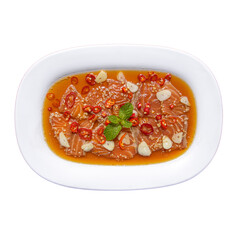 A vibrant dish featuring thinly sliced meat topped with chilies, garlic, and herbs in a flavorful sauce.