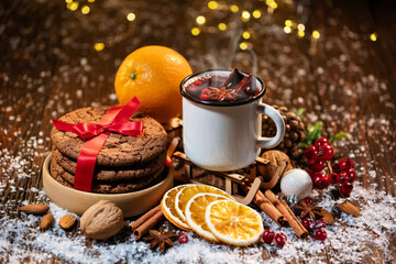 Close-up of traditional Christmas mulled wine with spices and cookies on Christmas market or fun fair
