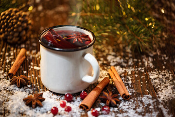Close-up of traditional Christmas mulled wine with spices on white mug on Christmas market