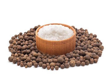Black peppercorns and a bowl of salt isolated on white
