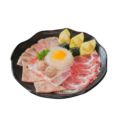 A beautifully arranged platter of assorted meats, accompanied by dumplings, an egg yolk, and garnished with fresh herbs.