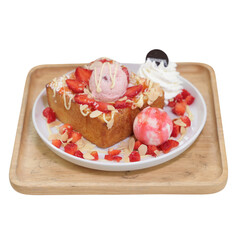 A delicious dessert featuring a thick slice of cake topped with various ice cream scoops, strawberries, whipped cream, and drizzled sauce.