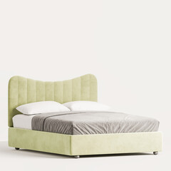 A bed with a green headboard and a white pillow