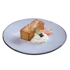 A golden, baked dessert slice served with cream, fruit garnish, and a dusting of powdered sugar on a gray plate.
