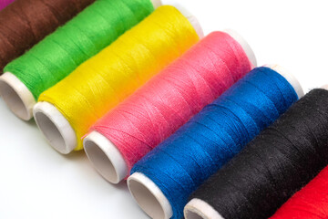 Colorful threads close-up on white background