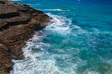 Obraz premium Coast and sea, beautiful rocky shore. Stoned coast and blue ocean fresh water