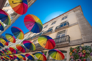 Pink Street - colorful umbrellas on the attractions tourism street of Lisbon in Portugal. New...