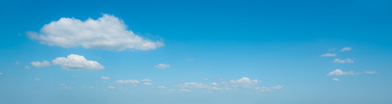 Cloudscape. Cumulus and fluffy lot clouds in the midday of blue sky. Dreamy sunshine in the sky. Beautiful sunny day