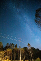 Silhouettes of pillars against the background of the starry sky with meteors