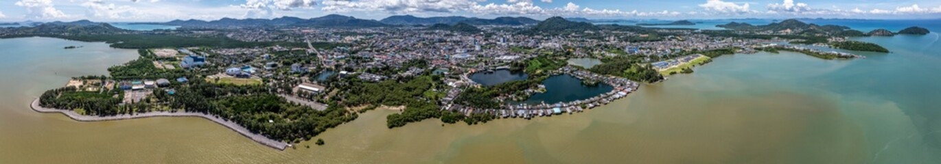Obraz premium 180° panoramic aerial view of Phuket Town, from Saphan Hin Park across downtown to Cape Tukkae with mountain landscape in background, located on Phuket Island, Thailand
