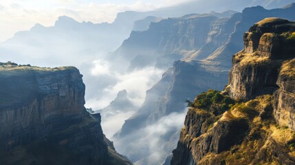 Majestic Mountain Landscape with Dramatic Cliffs and Misty Valley Revealing Natural Beauty in Early Morning Light