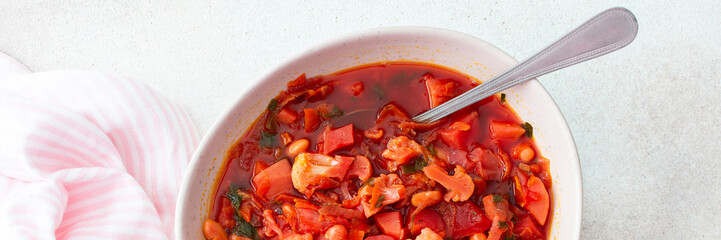 Red soup with beet, beans and vegetables and cauliflower, delicious hearty breakfasts or lunches, top view of a set table with food, banner