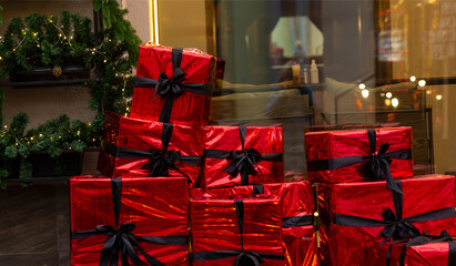 Red gift boxes on the street. Christmas decorations near the store