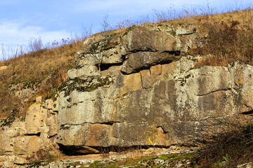 A large rock formation on the side of a hill