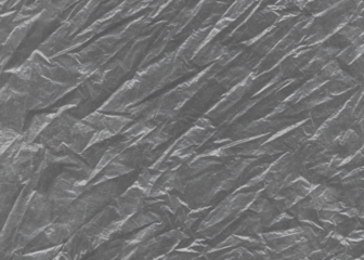 Сrumpled aluminum foil. Plastic transparent black cellophane background. Natural plastic texture surface.	