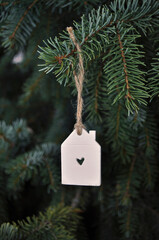 House ornament on christmas tree handmade of white clay. Home, Happy Holidays, Family, Love, Heart