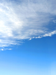Fototapeta premium Big White Fluffy Clouds on A Blue Sky With Fine Wispy Lines