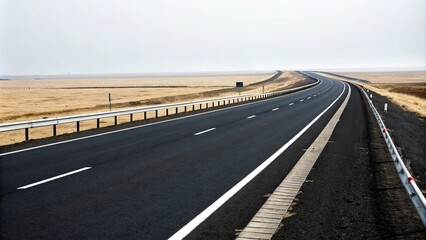Fototapeta premium Long stretch of black asphalt road with white dividing lines and single lane traffic, white stripes, winding path, solitary landscape, isolated highway