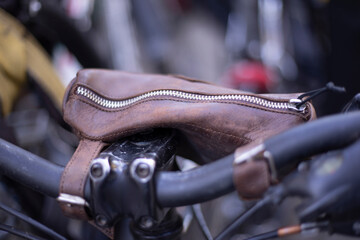 Leather bag on a bicycle. Wallet on the handlebars of a bicycle. Details of personal transport.