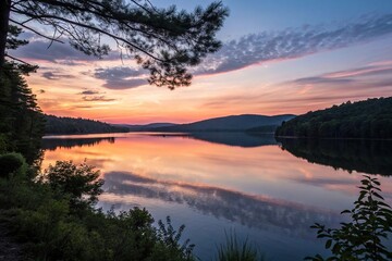 Fototapeta premium A kaleidoscope of warm hues reflected on the surface of a serene lake as day succumbs to night, gentle, water, warm