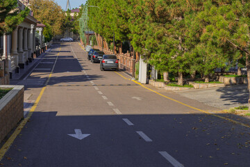 A dead end street in a residential area of the suburbs with a two-lane road, direction arrows,...