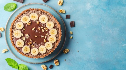 Fototapeta premium Banoffee pie, glazed with honey, chocolate and walnut sprinkles, topped with banana slices.