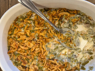 A Casserole Dish With Green Bean Casserole Dipped Out