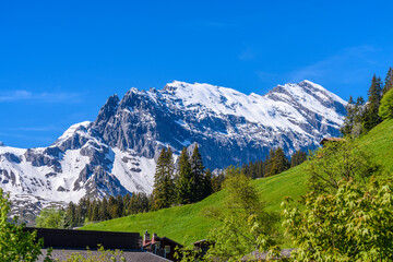 Beautiful Swiss mountain valley landscape with a house roof.