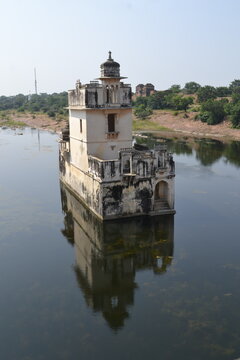 A majestic view of the submerged palace of Padmavati at Chittorgarh Fort. The ancient structure, partially hidden beneath the water, creates a captivating scene with its intricate architecture and ser