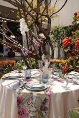 sophisticated and colorful table setting for lunch in the garden