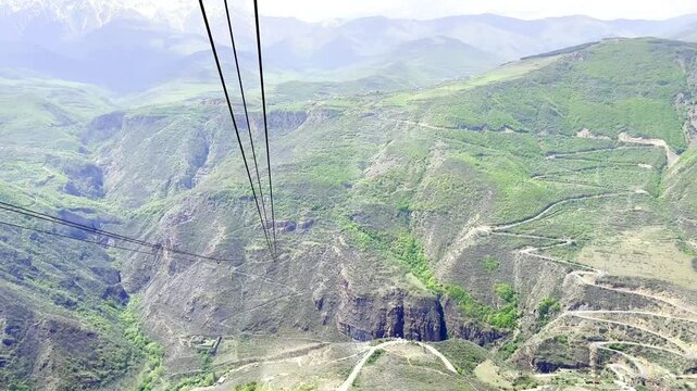 Airview from cable car in the longest ropeway cabin Wings of Tatev between Halidzor and Tatev monastery on canyon in spring time. Up the hill in nature park