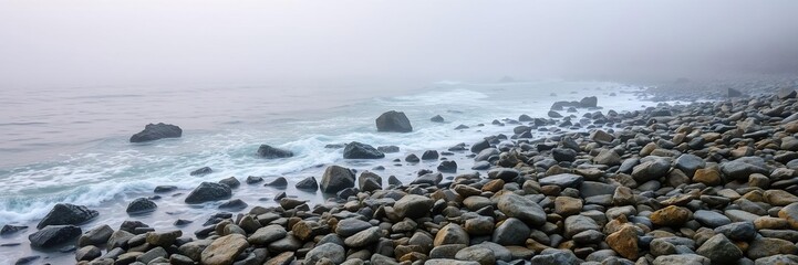 Obraz premium Misty morning on a rocky shoreline with sea spray, ethereal landscapes, mysterious ambiance, soft light